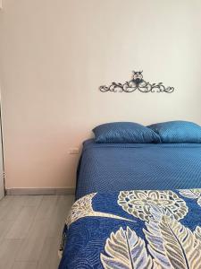 a bedroom with a bed with a blue comforter at Oasis in Montemorelos +6 photos