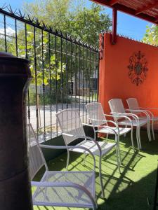 a group of white chairs sitting on a patio at Oasis in Montemorelos