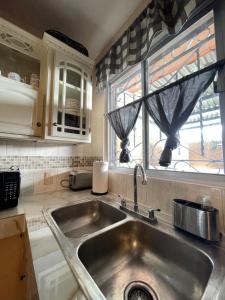 a kitchen with a sink and a window at Oasis in Montemorelos