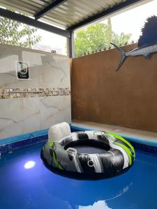 a swimming pool with an inflatable raft in the middle of it at Oasis in Montemorelos