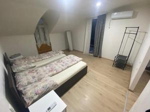 a room with two beds and a ladder in it at Marita Guesthouse in Batumi +2 photos