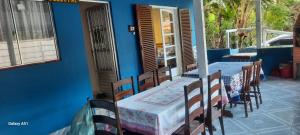 a dining room with two tables and chairs on a patio at Casa do Bem Viver in Trindade