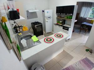a small kitchen with a sink and a refrigerator at Casa do Bem Viver in Trindade