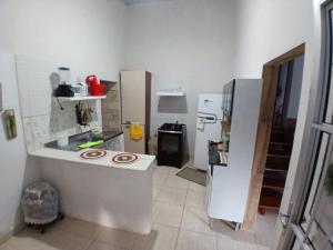 a small kitchen with a counter and a refrigerator at Casa do Bem Viver in Trindade