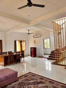 a living room with a ceiling fan and a table at Mangal Uday Villa in Jaipur