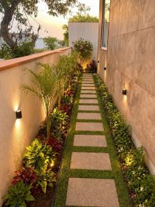 a garden with a walkway with plants and lights at Mangal Uday Villa in Jaipur