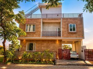 a house with a car parked in front of it at Mangal Uday Villa in Jaipur