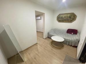 a small room with a bed and a table at Marita Guesthouse in Batumi