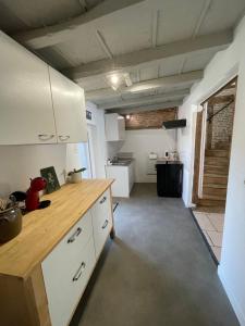 a kitchen with a wooden counter top in a room at Maison de campagne 110m2 in Longeault +22 photos