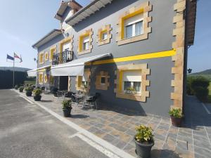 a building with tables and chairs outside of it at Posada Gran Sol in Queveda +19 photos