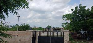 a fence with a gate in front of a building at DeBoss Arena in Abeokuta