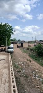 a van parked on the side of a dirt road at DeBoss Arena in Abeokuta