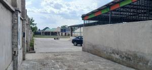 a car parked in a parking lot next to a building at DeBoss Arena in Abeokuta