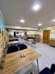 a restaurant with tables and chairs in a room at Hotel Al Amir palace boutique in Bukhara +103 photos