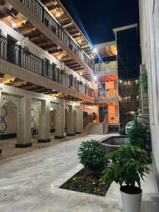 a large building with a courtyard with plants in it at Hotel Al Amir palace boutique in Bukhara
