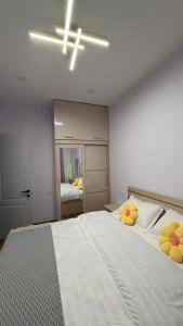 a bedroom with a large bed with yellow pillows on it at Sunset Telavi in Telavi +10 photos