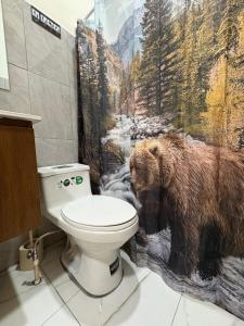 a bathroom with a bear shower curtain and a toilet at Apartment Nazareth in La Unión +28 photos