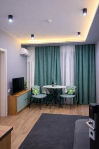 a living room with a table and two chairs at Sunset Telavi in Telavi