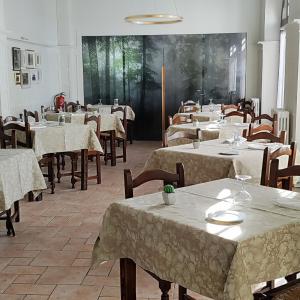 a dining room with tables and chairs with white table cloth at Hostal Ayestaran II in Lekunberri