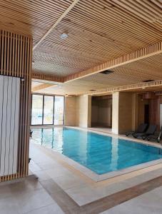 a large swimming pool with a wooden ceiling at Oblivion 1 in Velingrad