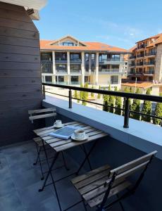 a balcony with a table and chairs on a building at Oblivion 1 in Velingrad