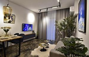 a living room with a couch and a table at Oblivion 1 in Velingrad