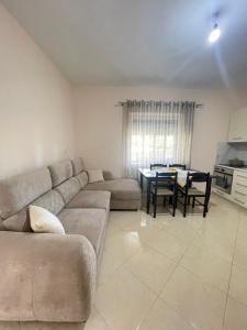 a living room with a couch and a table at eljos house permet in Përmet