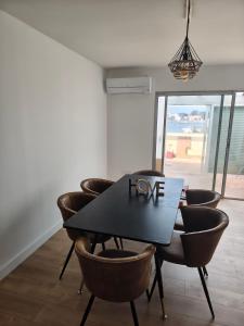 a dining room table with a sign that says love at Résidence soleilla in Le Barcarès