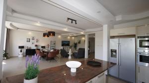 a kitchen and living room with a table and a living room at Rubens Loft four bedrooms two bathrooms in Antwerp