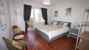 a bedroom with a bed and two chairs in it at Rubens Loft four bedrooms two bathrooms in Antwerp
