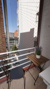 a balcony with a table and a bench on a building at Rubens Loft four bedrooms two bathrooms in Antwerp