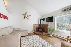 a living room with a couch and a fireplace at Butternut Hill D5 in Waitsfield