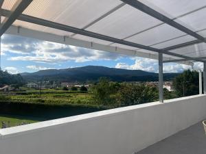 a view from the balcony of a house with a white roof at pensión Palongo in Caldas de Reis +7 photos