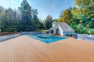 a large backyard with a swimming pool and a house at Butternut Hill D5 in Waitsfield