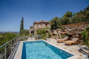 a villa with a swimming pool and a house at Villa Aethra in Riglia