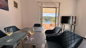a dining room with two glasses of white wine at SFE Apartment in Milna