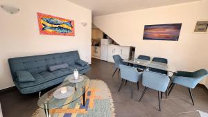 a living room with a couch and a table and chairs at SFE Apartment in Milna +17 photos