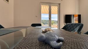 a toy turtle laying on a dining room table at SFE Apartment in Milna