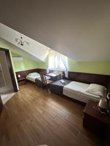 a hotel room with two beds and a table at Pokoje Hotelowe Wiktoria in Goczałkowice Dolne