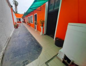 an orange building with a toilet outside of it at 7 duendes in Salta