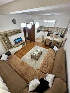 a living room with a couch and a dining room at White Hill in Ulcinj