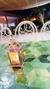 a lantern sitting on top of a table at Riad NACIRIA in Aït Ourir