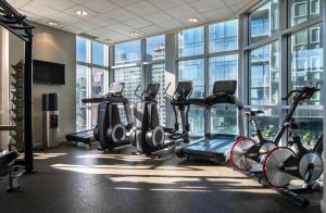 a gym with a bunch of exercise bikes in a room with windows at Warwick Le Crystal - Montréal in Montreal +29 photos
