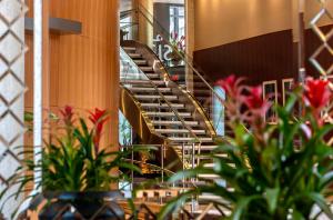 a spiral staircase in a building with plants at Warwick Le Crystal - Montréal in Montreal