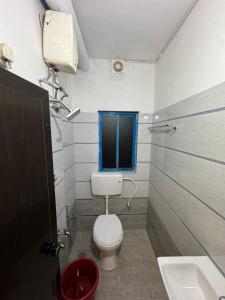 a small bathroom with a toilet and a sink at Udupi Shri Krishna Dormitary Bed Space in Udupi