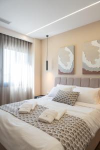 a large white bed with two pillows on it at Antaia 4 in Nafplio