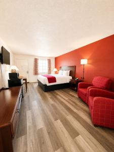 a hotel room with a bed and a couch at Carriage House Inn in Branson