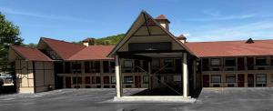 a large building with a parking lot in front of it at Red Roof Inn Helen, GA - Downtown in Helen