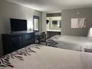 a hotel room with two beds and a flat screen tv at Red Roof Inn Helen, GA - Downtown in Helen