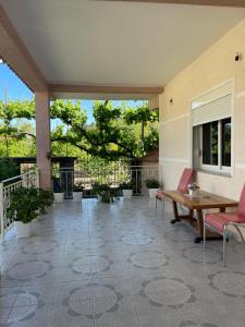 a patio with a table and chairs on a patio at eljos house permet in Përmet